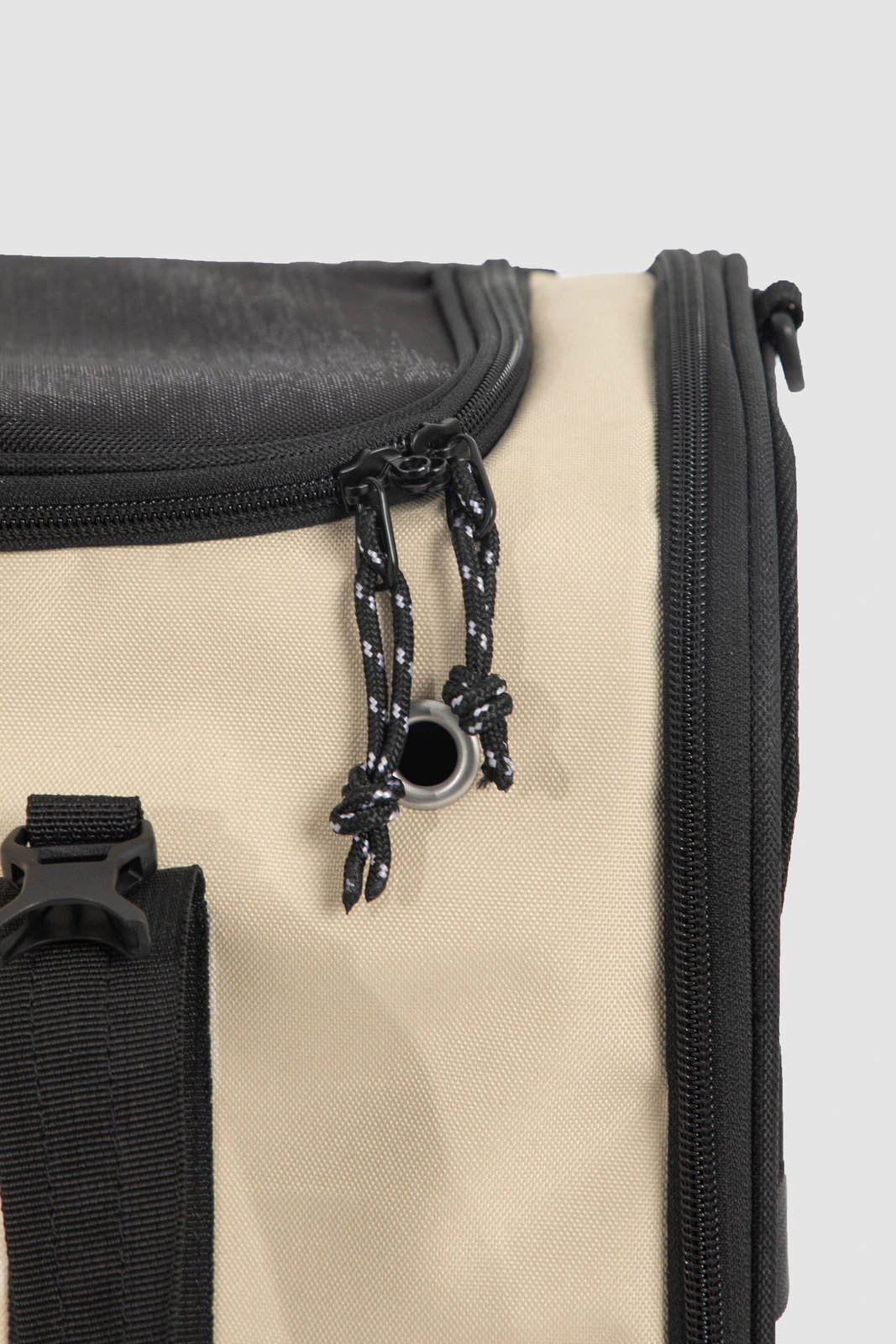 Top mesh zipper, cord pulls and reinforced fabric eyelet