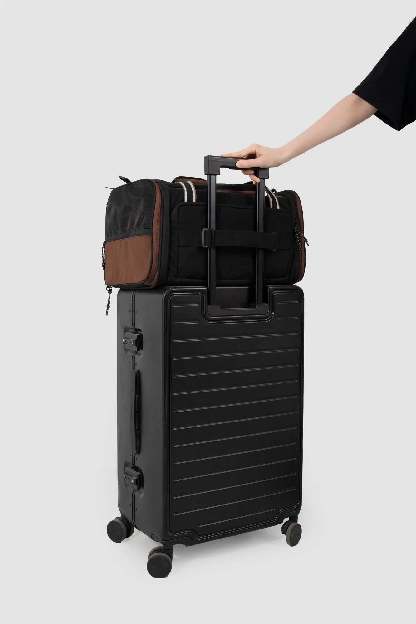 Rear luggage sleeve secured to a suitcase handle