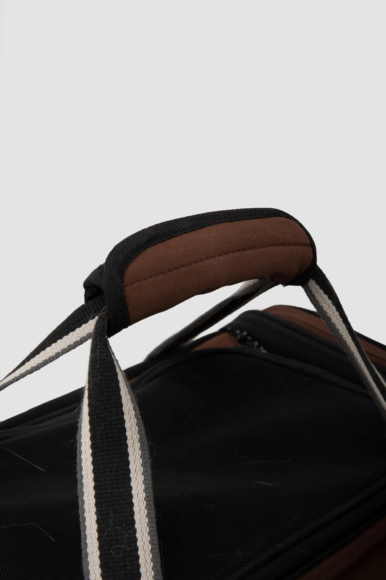 Padded carry handle and woven straps
