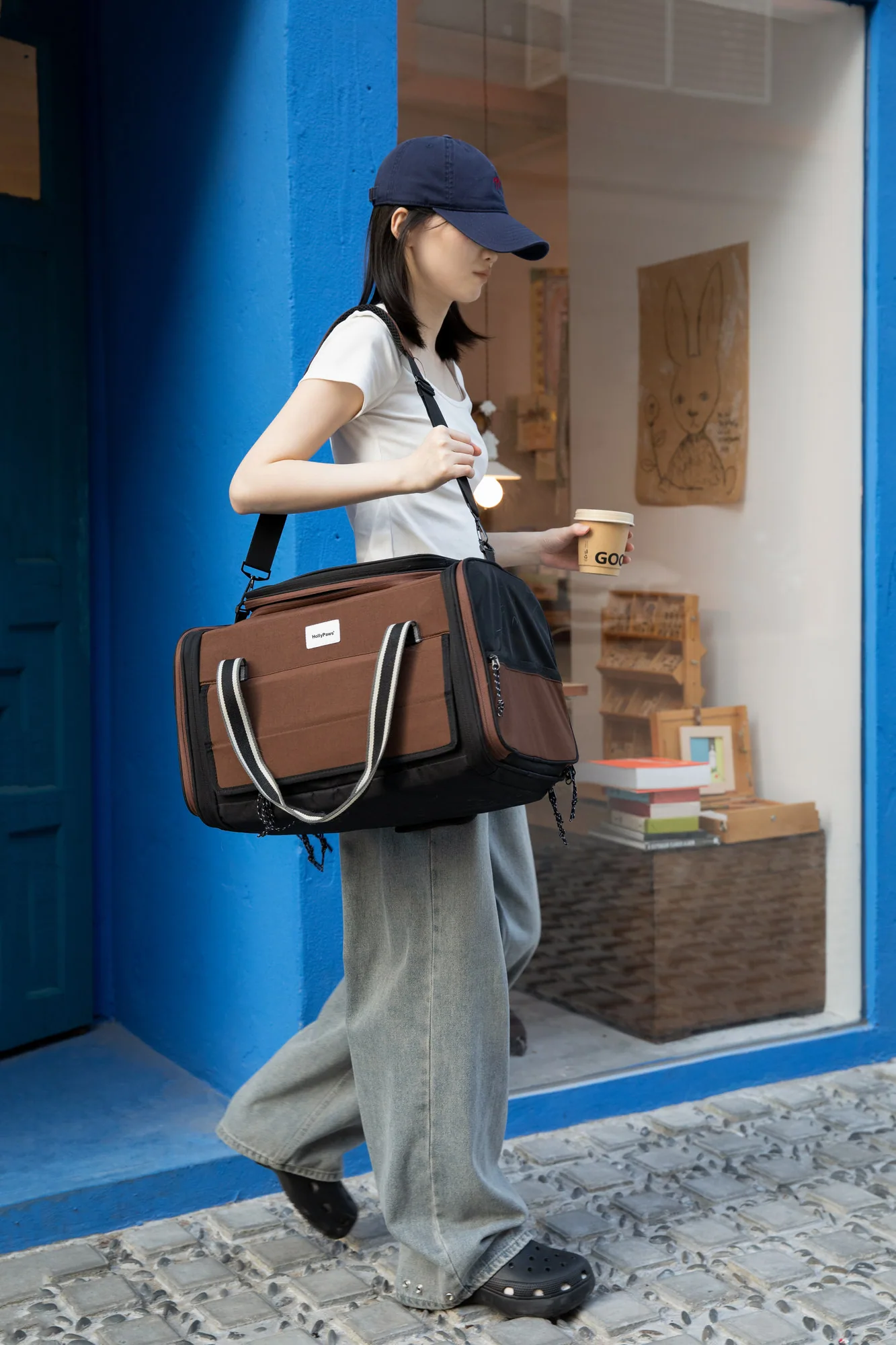 Traveller carrying the pet carrier with a shoulder strap