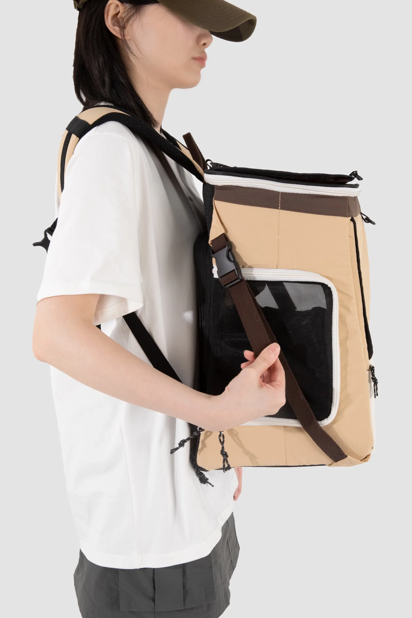 Carrier worn as a backpack with the front support strap adjusted