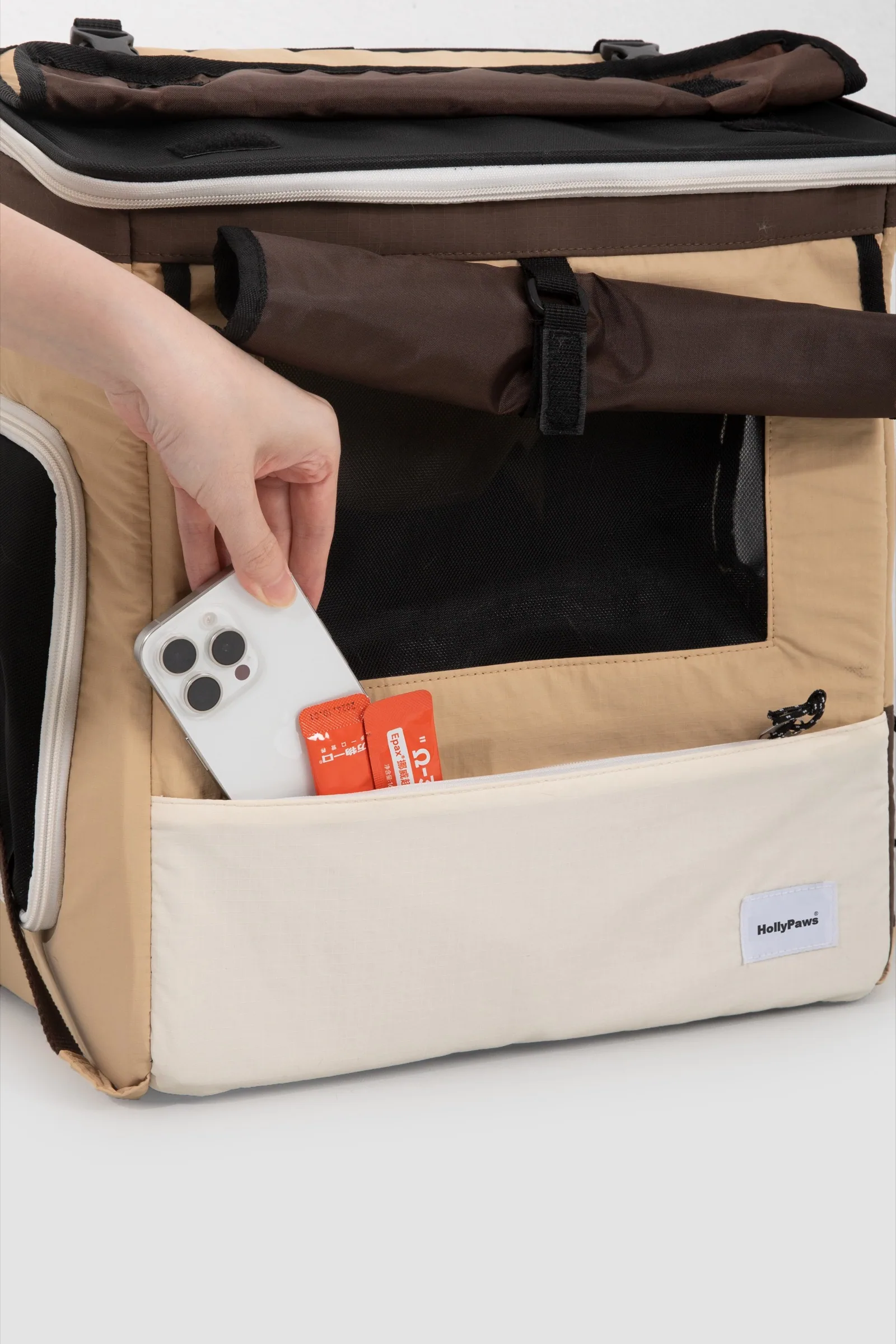 Front storage pocket holding a phone and small travel items
