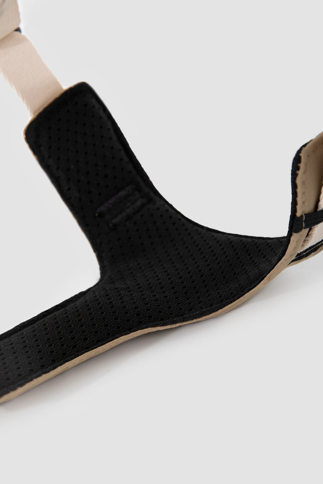 Close-up of black mesh lining and bound padded edges