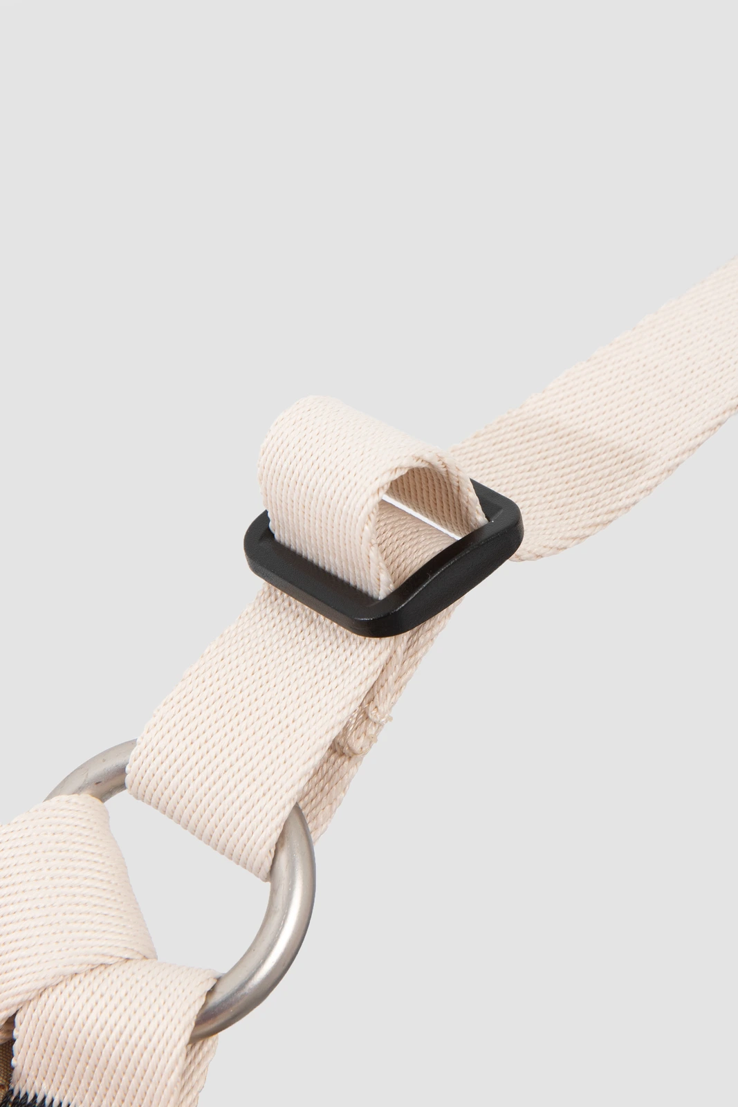 Close-up of webbing adjuster and attachment-ring stitching
