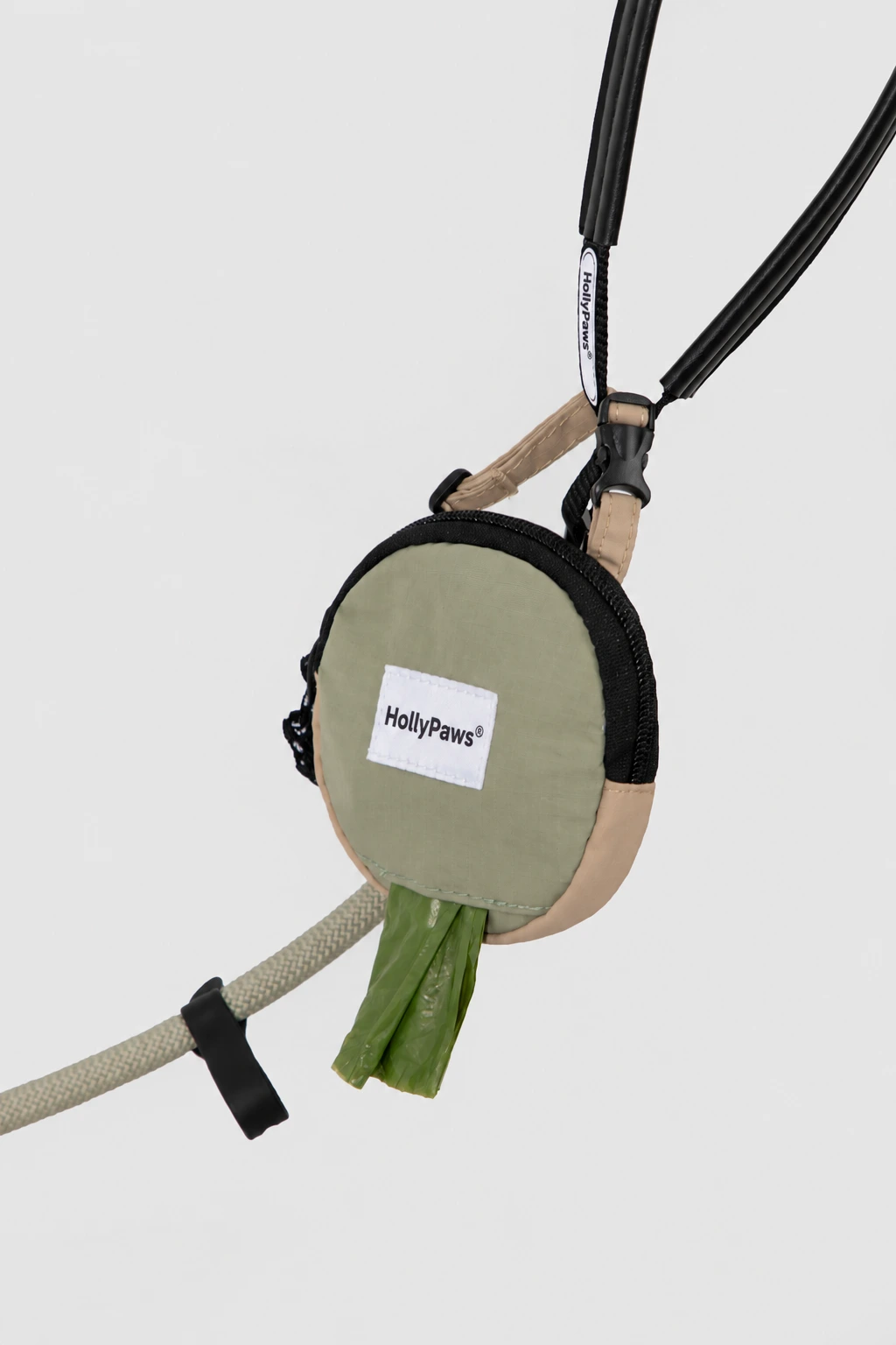 Olive-and-tan sample pouch clipped to a leash with a bag emerging from the opening