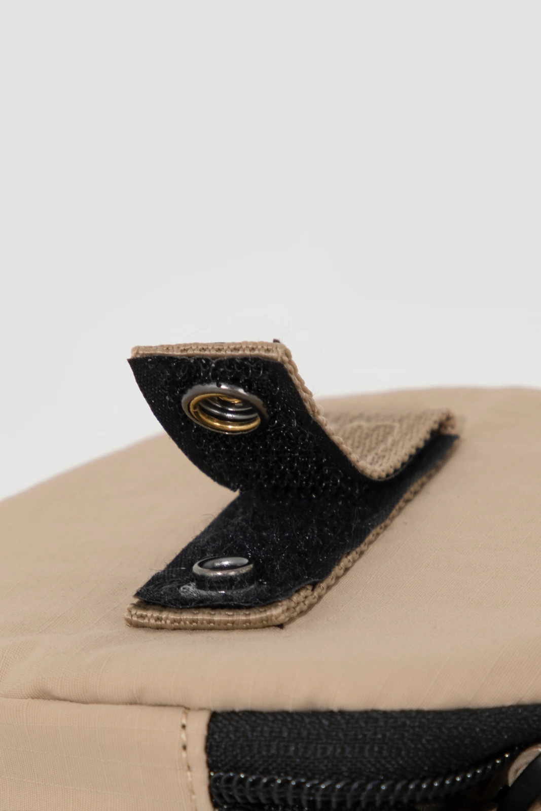 Close-up of snap closure, binding and zipper construction